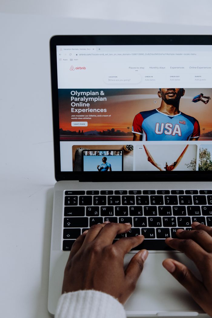 home-img Hands using a laptop to browse online Olympic and Paralympic experiences.