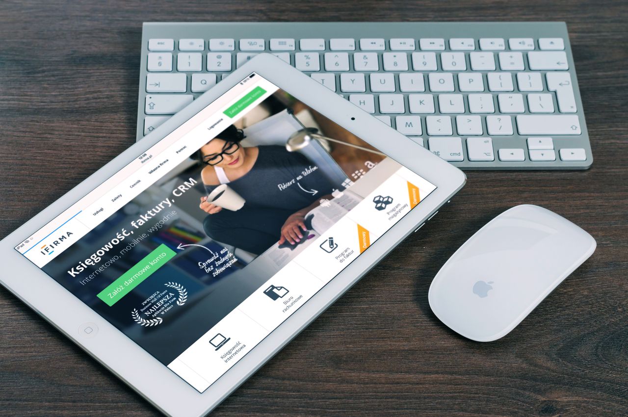 gallery-02 A tablet with a financial website open, alongside a white keyboard and mouse. Ideal for tech-theme stock images.